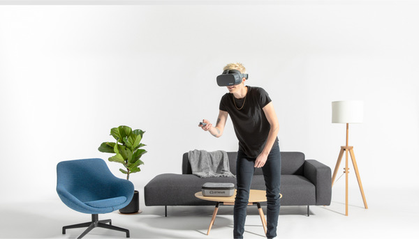 Man in a living room using VR training to learn.