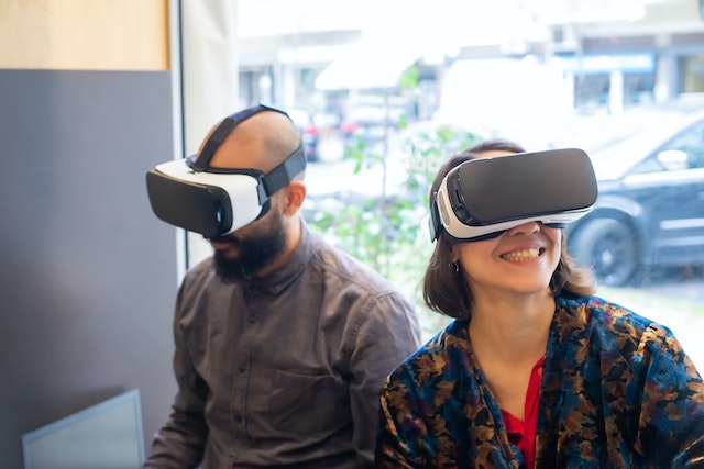 man and woman with vr headsets engage in a virtual environment