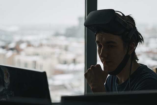 man with vr headset at his computer