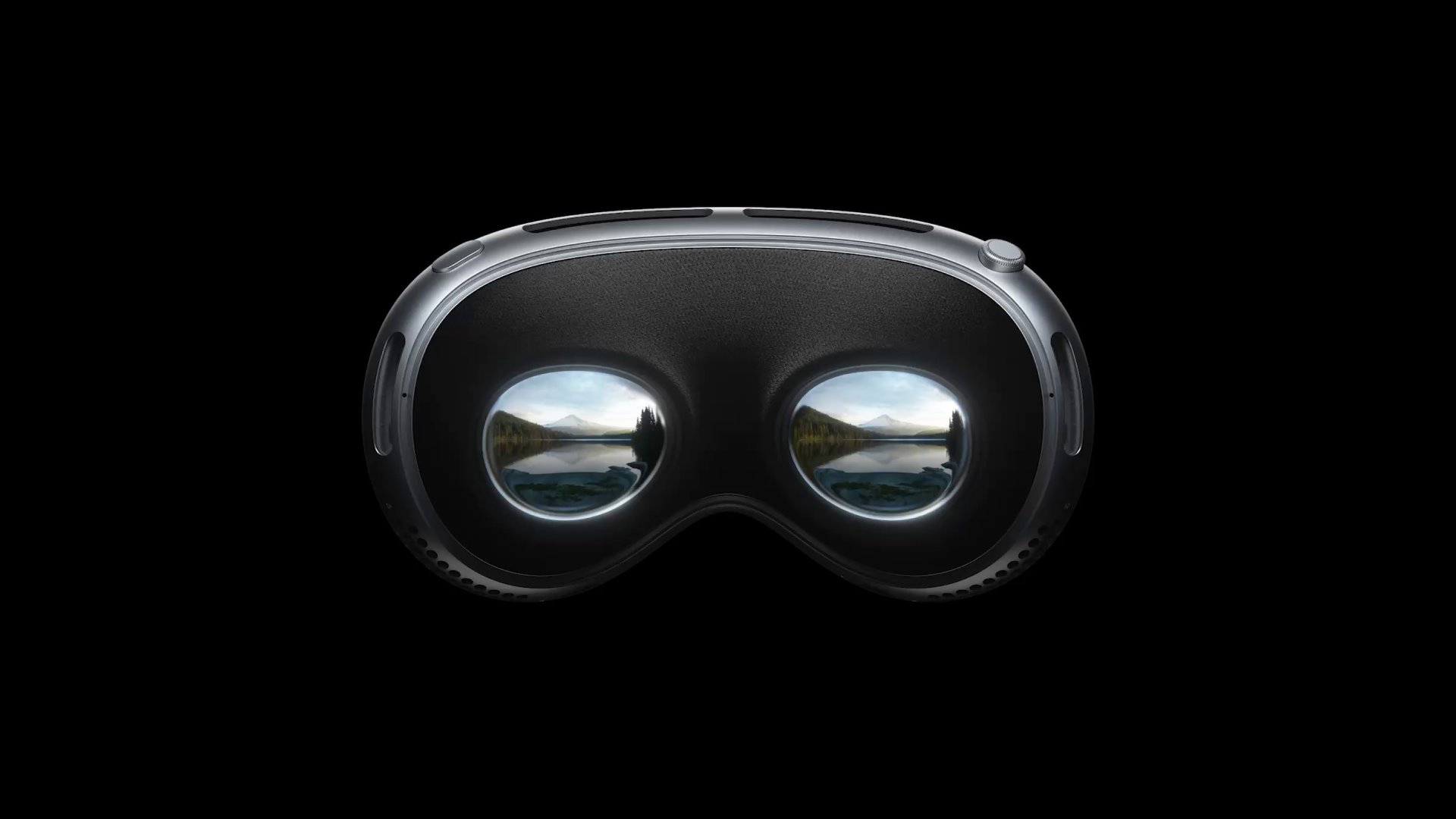 Close-up of high-resolution virtual reality goggles with a scenic mountain lake reflected in the lenses.